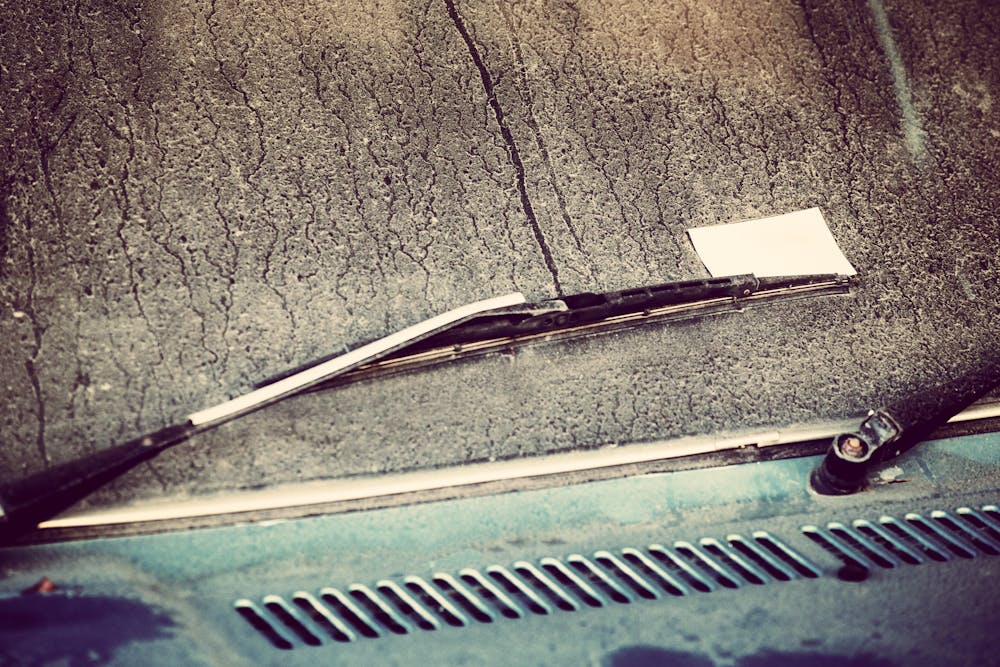 Wiper blades are seen on a wet windshield