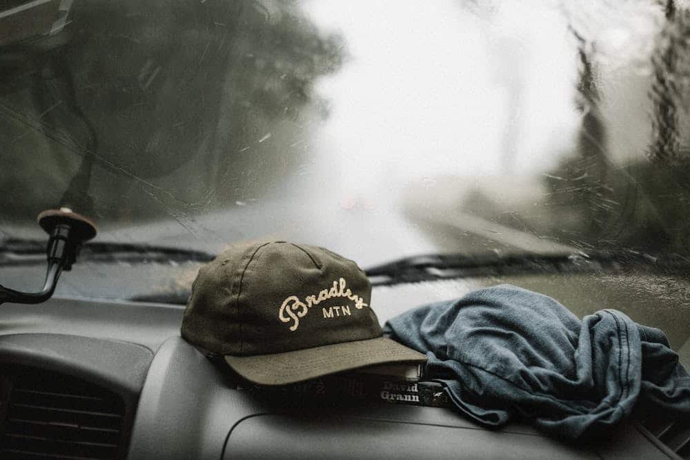 A foggy windshield is seen from inside a car